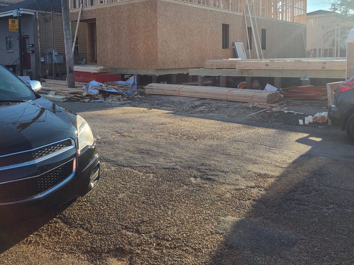Two-story home framing with roof rafters and a ground floor sheathed in OSB