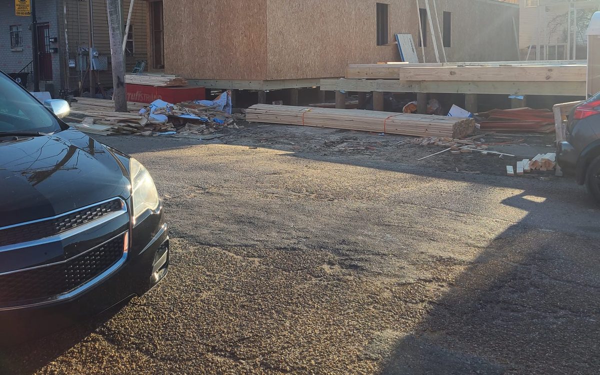 Two-story home framing with roof rafters and a ground floor sheathed in OSB