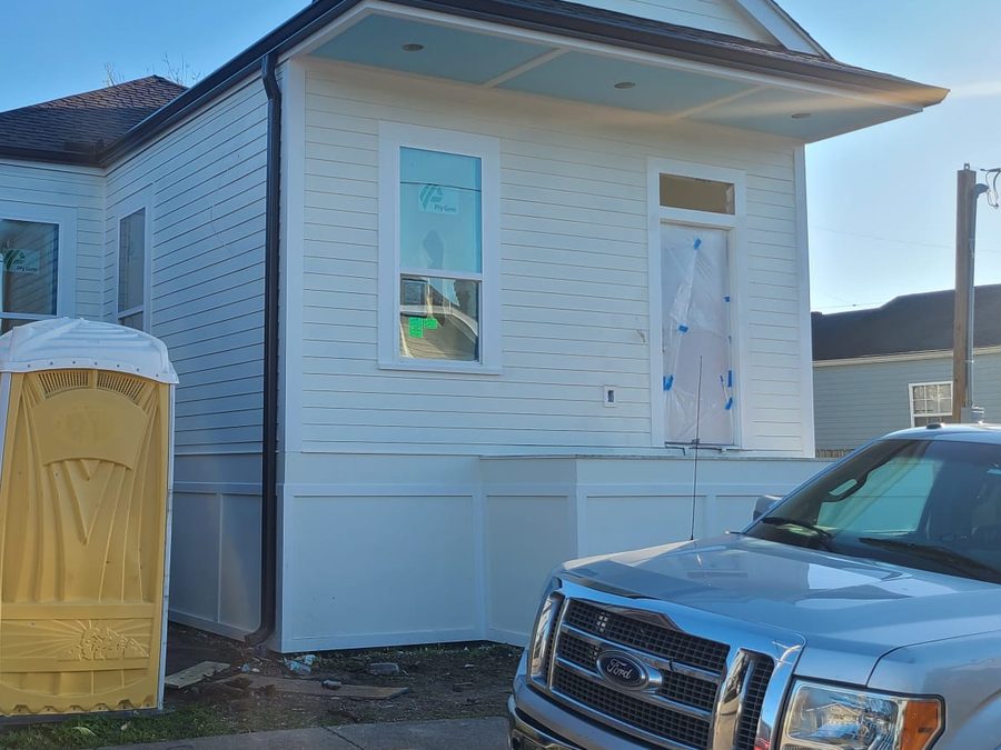 Newly built white home with lap siding and a covered front porch