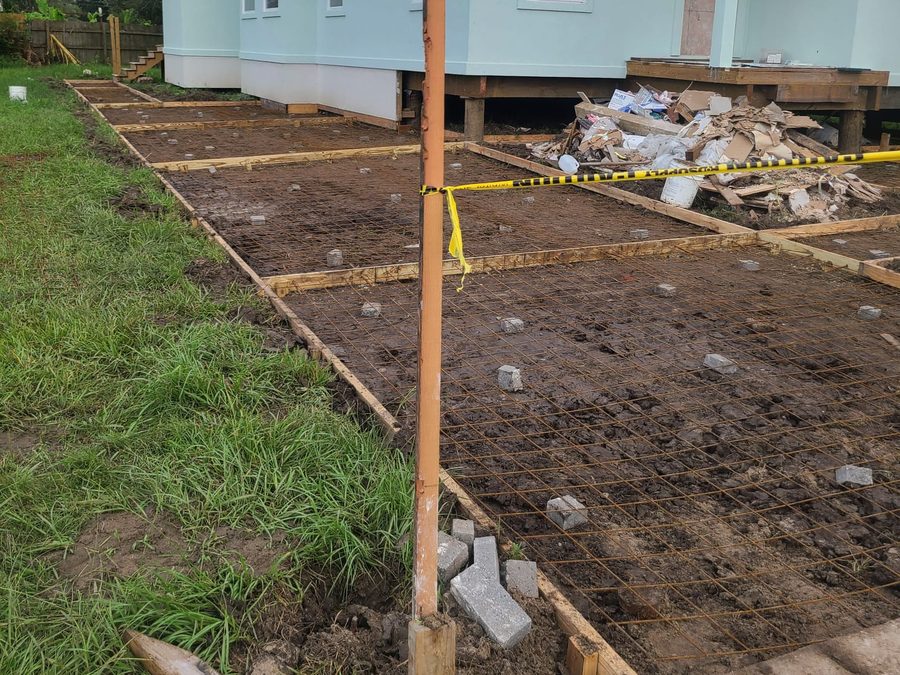 Formed and reinforced walkway ready for concrete in front of a new stucco home