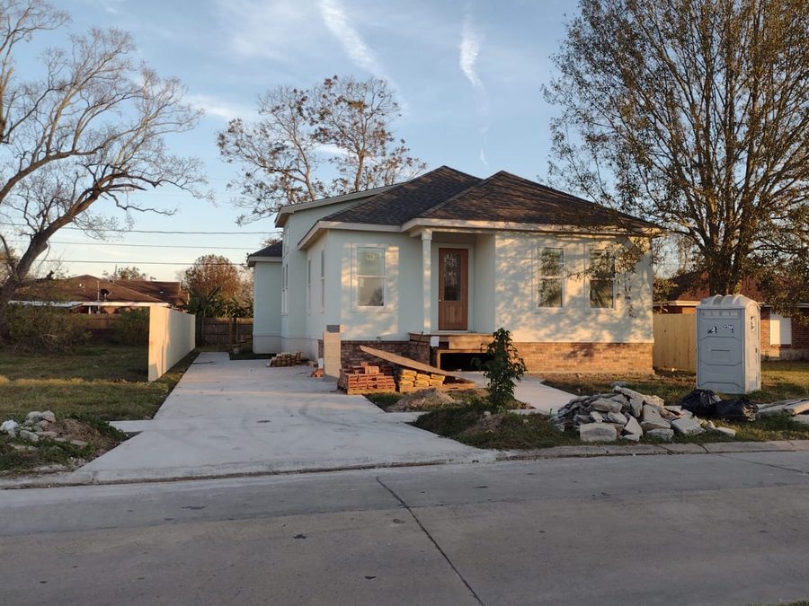 Finished mint-green home with a new concrete driveway and front walkway