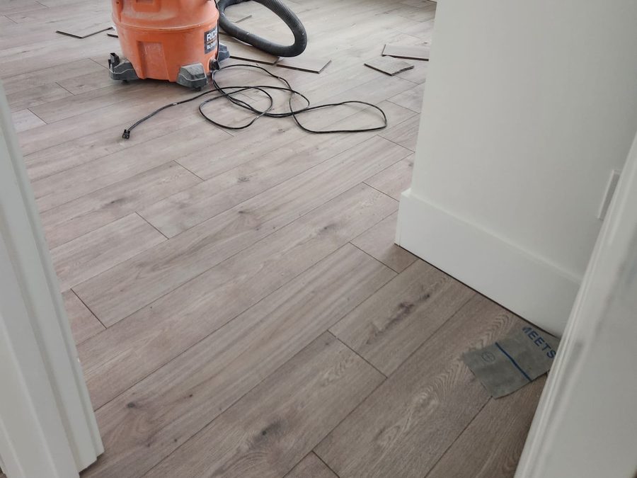 New wood-look plank flooring installed in a bright bedroom