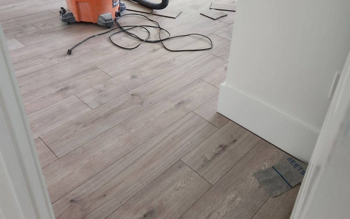 New wood-look plank flooring installed in a bright bedroom