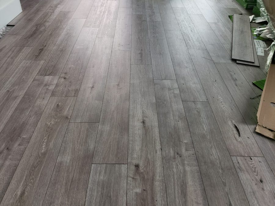 New plank flooring being installed in an open living area