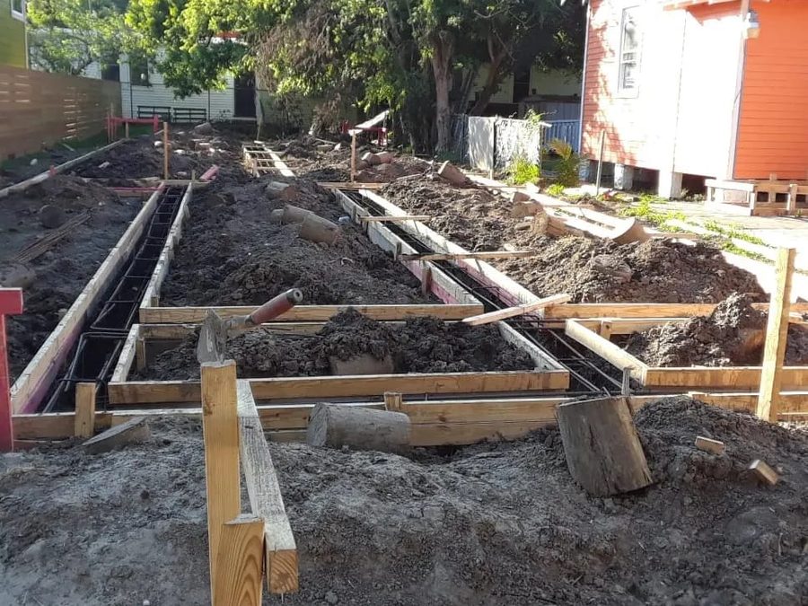 Formed footings with rebar laid out across a residential lot