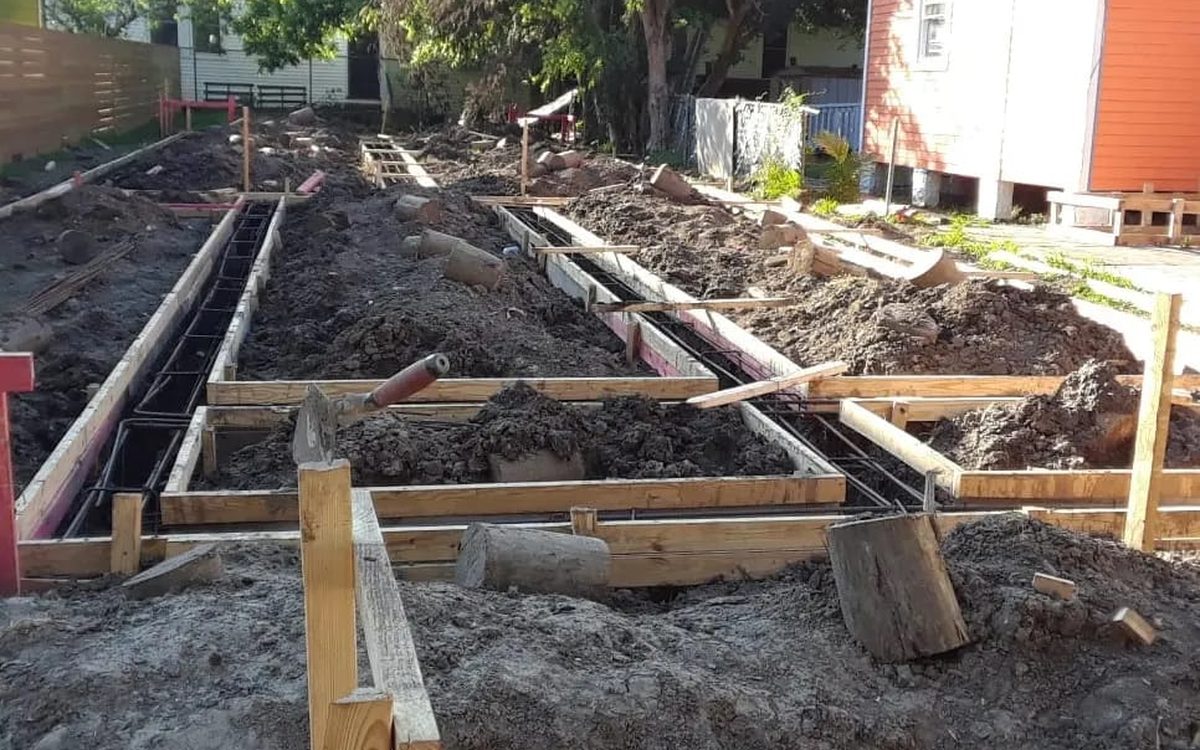 Formed footings with rebar laid out across a residential lot