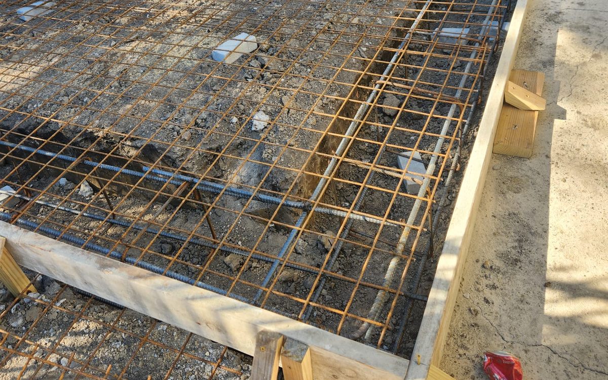 Reinforced slab area with mesh, rebar and forms at a home entrance