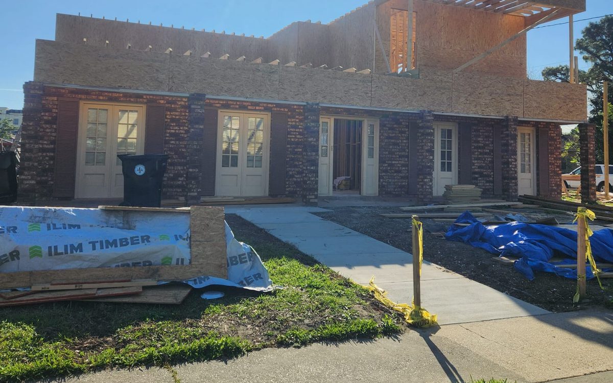 Second-story addition framed and sheathed above a brick ranch home